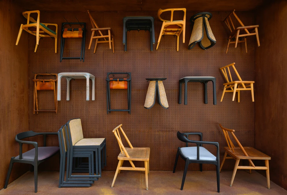 Assorted wooden and cane chairs displayed in a showroom setting